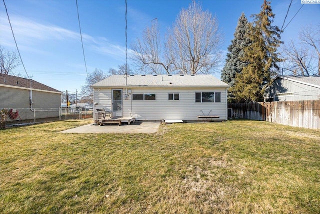 back of property with a patio area and a lawn