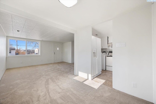 unfurnished living room with light carpet