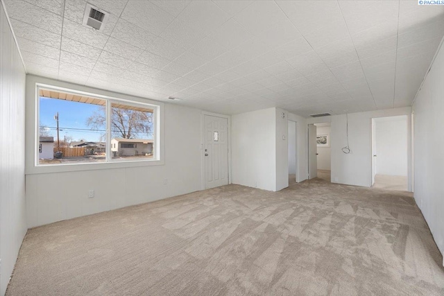 empty room featuring light colored carpet