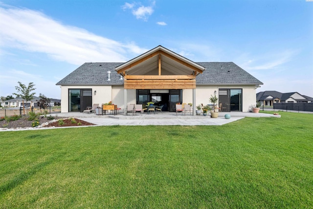 7004 Ricky Rd, Pasco, WA 93301 - back of property featuring a patio, a lawn, fence, and stucco siding