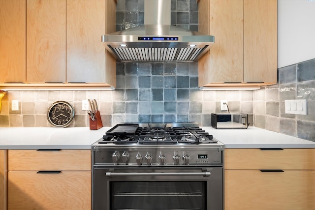 7004 Ricky Rd, Pasco, WA 93301 - kitchen with light brown cabinetry, high end range, light countertops, and wall chimney range hood