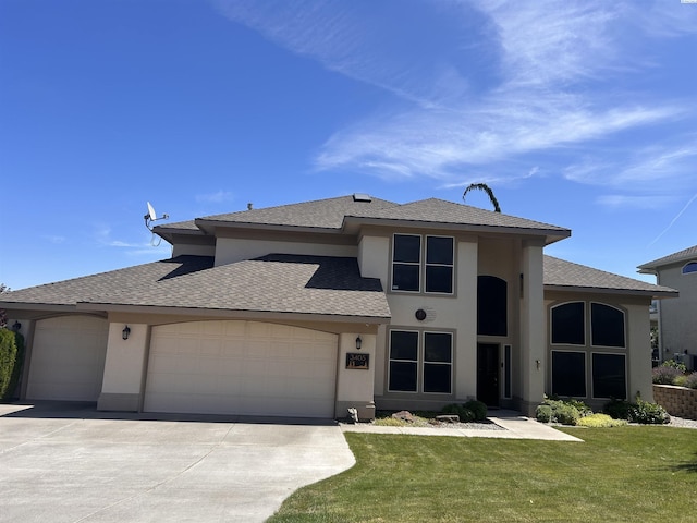 3405 S Johnson St, Kennewick, WA 99337 - view of front of property with a garage, concrete driveway, stucco siding, a front lawn, and roof with shingles