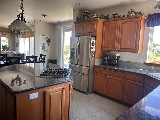 3405 S Johnson St, Kennewick, WA 99337 - kitchen with stainless steel appliances, healthy amount of natural light, and brown cabinets