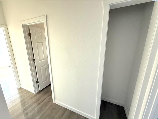 interior space with baseboards and light wood-style floors