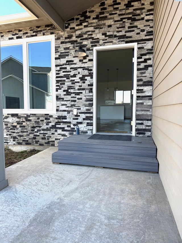 doorway to property with stone siding