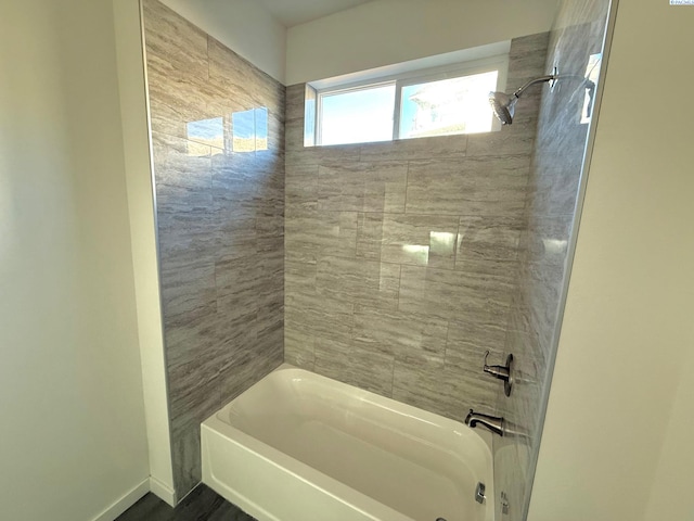 full bath featuring  shower combination and baseboards