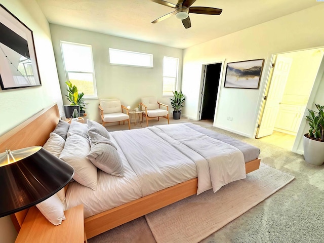 bedroom featuring light carpet, a ceiling fan, and baseboards