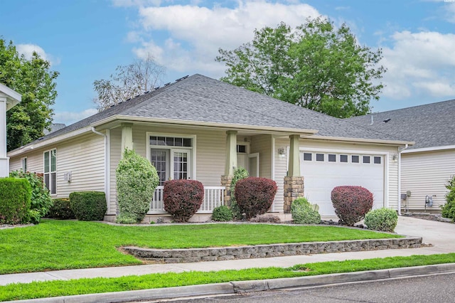 ranch-style home featuring covered porch, a front yard, and a garage