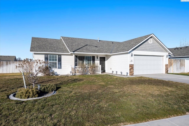 single story home with a garage, a front yard, and covered porch