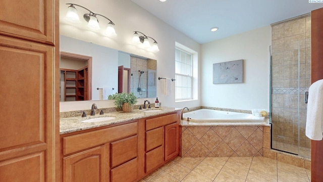 full bathroom with a shower stall, tile patterned floors, a bath, double vanity, and a spacious closet