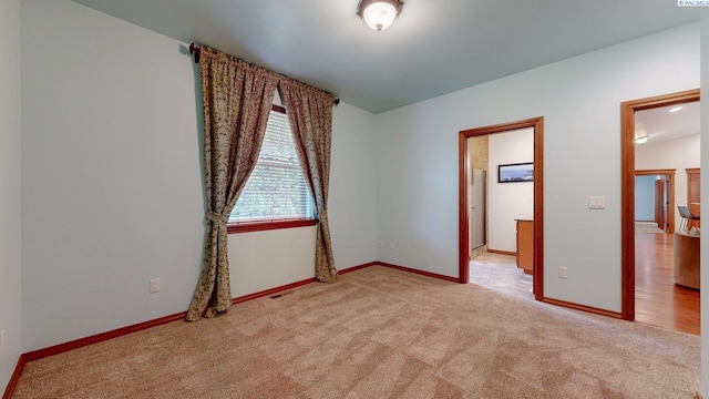 empty room with carpet floors and baseboards