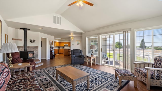 151002 W Richards Rd, Prosser, WA 99350 - living area featuring lofted ceiling, a ceiling fan, dark wood finished floors, and a wood stove