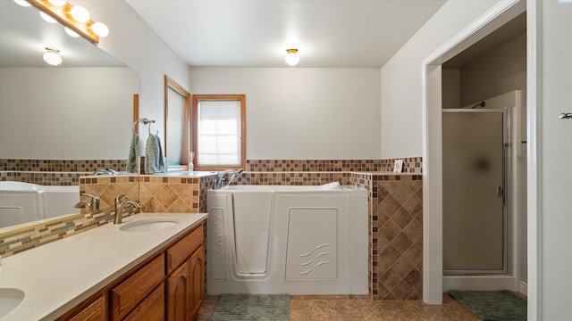 151002 W Richards Rd, Prosser, WA 99350 - bathroom featuring tile walls, a garden tub, a shower stall, double vanity, and wainscoting