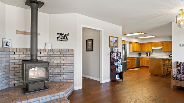 151002 W Richards Rd, Prosser, WA 99350 - living area featuring a wood stove and dark wood-style flooring
