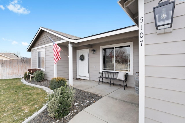 view of exterior entry with a yard