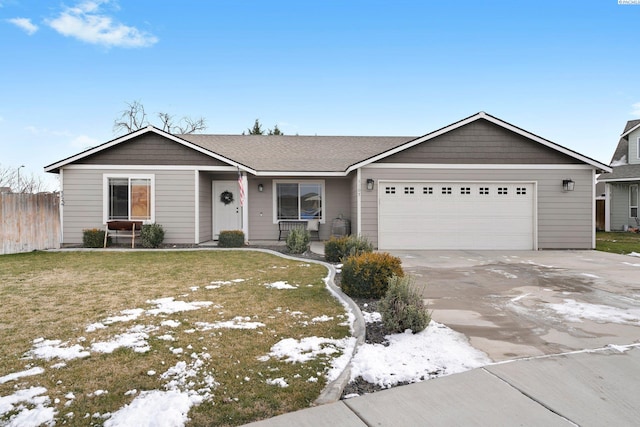 ranch-style house with a garage and a front lawn