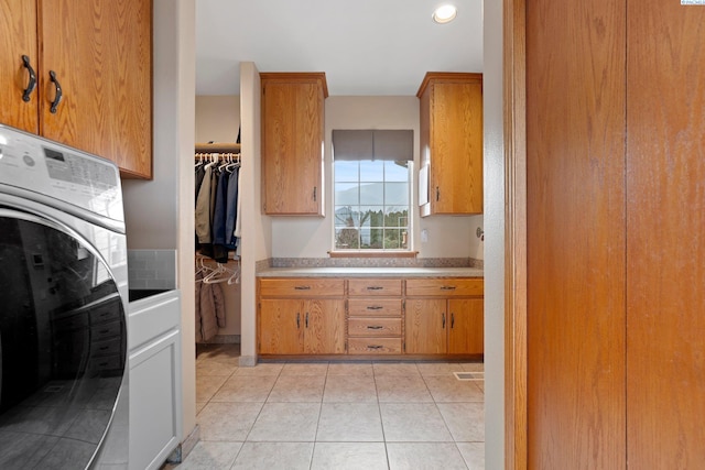 kitchen featuring washer / clothes dryer and light tile patterned floors