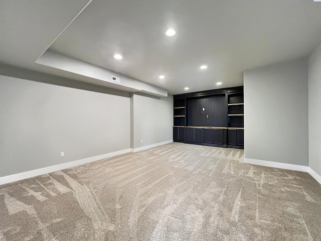 finished basement featuring light carpet, recessed lighting, visible vents, and baseboards