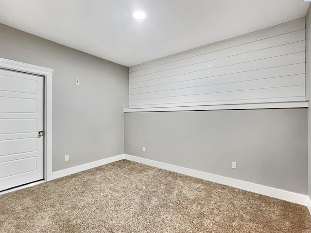 carpeted empty room with baseboards