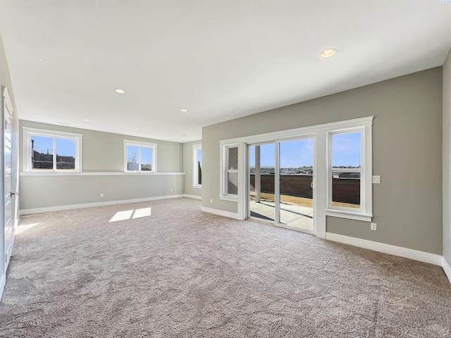 carpeted spare room featuring baseboards and recessed lighting