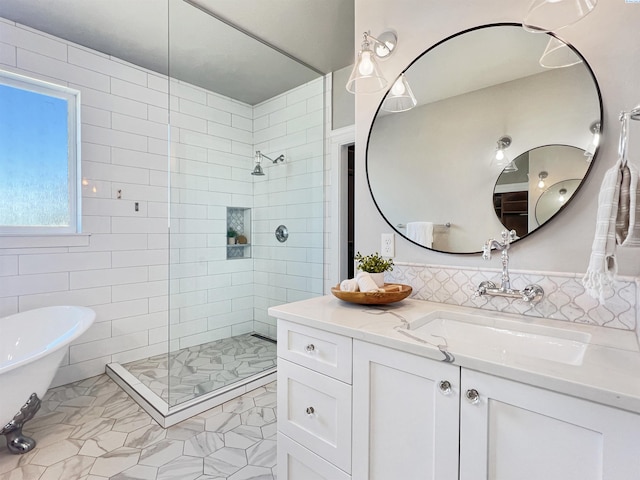 full bath featuring a freestanding bath, a tile shower, vanity, and tile walls