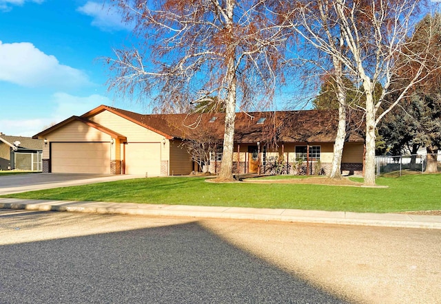 ranch-style house featuring a garage and a front yard