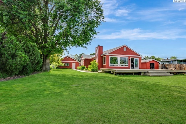 1706 Gaillard Pl, Richland, WA 99354 - rear view of house featuring a deck, a lawn, a chimney, and a garage