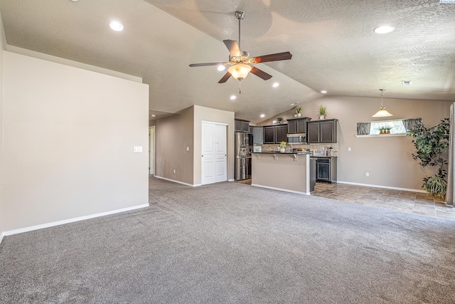 3313 Aqueduct Ln, Pasco, WA 99301 - unfurnished living room with light carpet, vaulted ceiling, a ceiling fan, baseboards, and recessed lighting