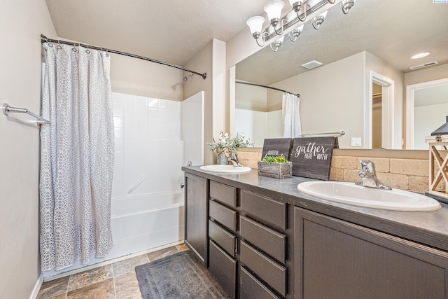 3313 Aqueduct Ln, Pasco, WA 99301 - full bathroom with double vanity, shower / bath combo with shower curtain, and stone finish floors