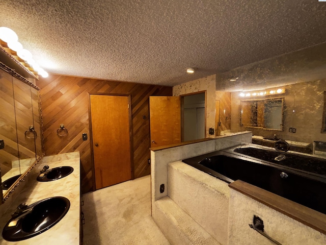 1630 NE Gaines Rd, Pullman, WA 99163 - full bath with a textured ceiling, a garden tub, wooden walls, and vanity