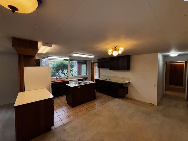 1630 NE Gaines Rd, Pullman, WA 99163 - kitchen featuring freestanding refrigerator, a kitchen island, black electric cooktop, light countertops, and a sink