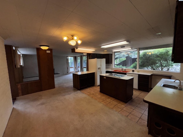 1630 NE Gaines Rd, Pullman, WA 99163 - kitchen featuring a kitchen island, a sink, white appliances, and light carpet