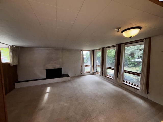 1630 NE Gaines Rd, Pullman, WA 99163 - unfurnished living room featuring a brick fireplace, healthy amount of natural light, and carpet