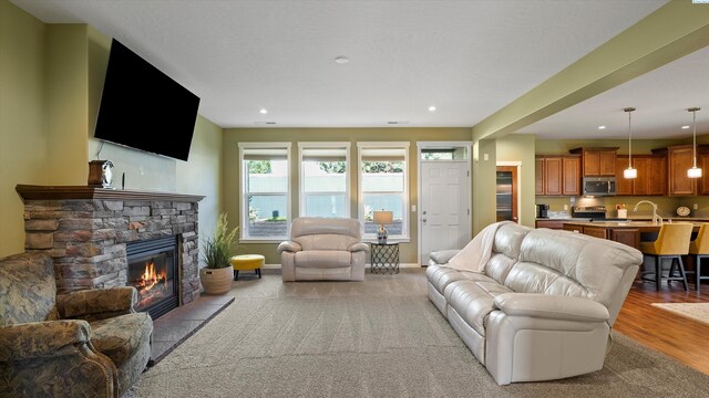 6102 Westmoreland Ln, Pasco, WA 99301 - living area featuring a fireplace, recessed lighting, and light wood-type flooring