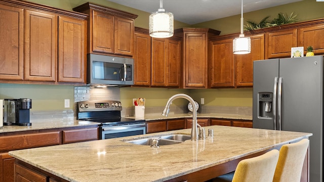6102 Westmoreland Ln, Pasco, WA 99301 - kitchen with stainless steel appliances, brown cabinets, and pendant lighting