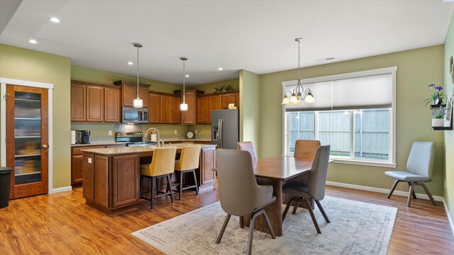6102 Westmoreland Ln, Pasco, WA 99301 - dining area with a chandelier, wood finished floors, and recessed lighting