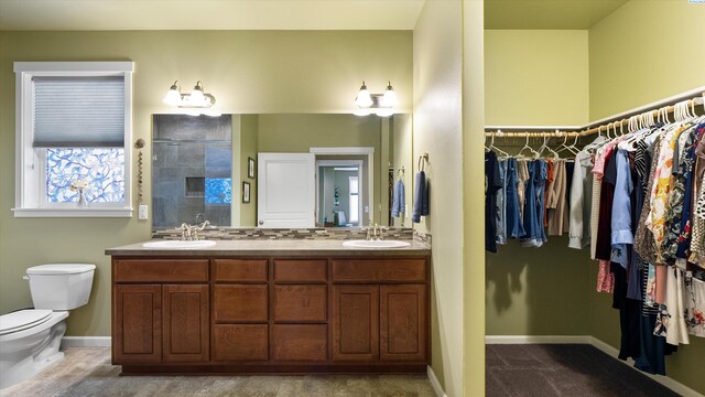 6102 Westmoreland Ln, Pasco, WA 99301 - full bathroom featuring double vanity, a shower stall, and a spacious closet