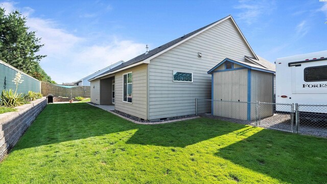 6102 Westmoreland Ln, Pasco, WA 99301 - back of house with a fenced backyard, a storage shed, and crawl space