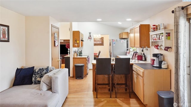 235 E Lilac Pl, Othello, WA 99344 - kitchen featuring freestanding refrigerator, light wood-style floors, open floor plan, lofted ceiling, and recessed lighting