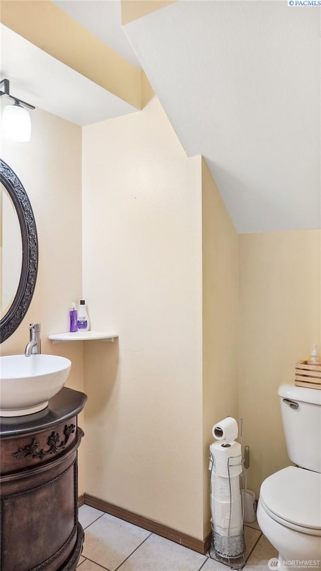 235 E Lilac Pl, Othello, WA 99344 - half bathroom featuring tile patterned floors, toilet, baseboards, and vanity