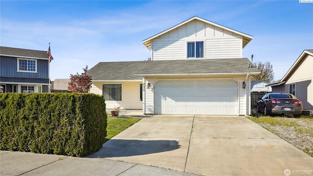 235 E Lilac Pl, Othello, WA 99344 - traditional home featuring an attached garage, driveway, board and batten siding, and a shingled roof