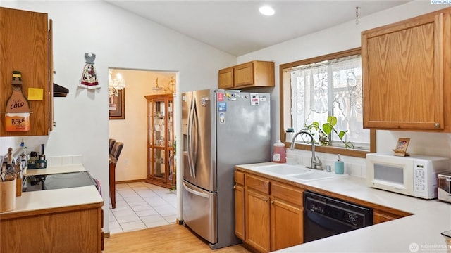 235 E Lilac Pl, Othello, WA 99344 - kitchen with a sink, black dishwasher, stainless steel fridge with ice dispenser, white microwave, and lofted ceiling