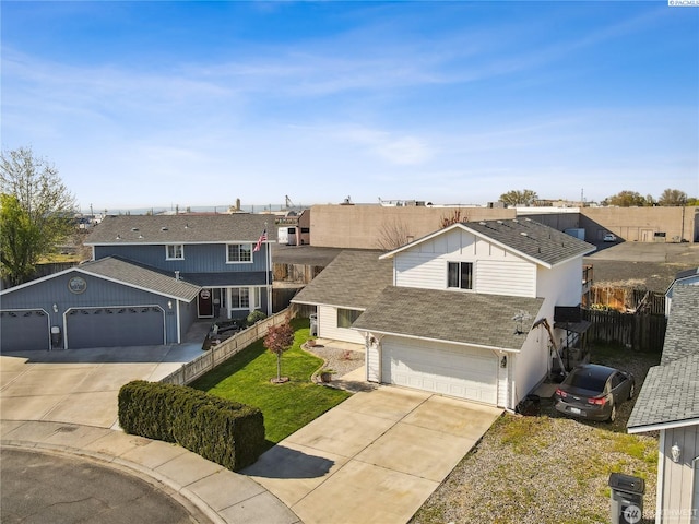 235 E Lilac Pl, Othello, WA 99344 - traditional-style house with concrete driveway, roof with shingles, and a residential view