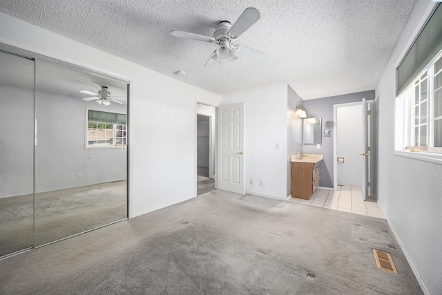 706 W 42nd Ave, Kennewick, WA 99337 - unfurnished bedroom with carpet floors, a textured ceiling, a closet, a ceiling fan, and ensuite bath