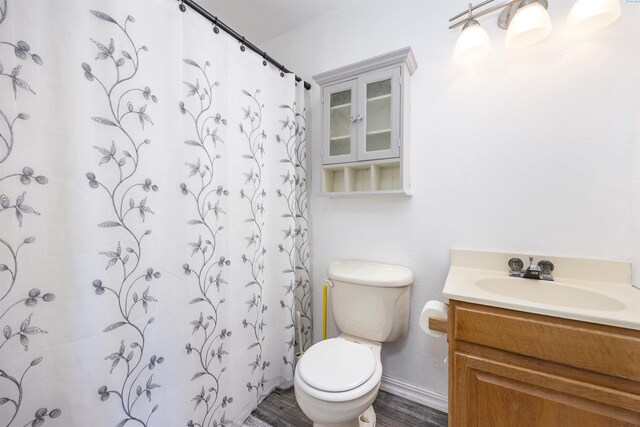706 W 42nd Ave, Kennewick, WA 99337 - full bathroom with vanity, toilet, wood finished floors, and curtained shower