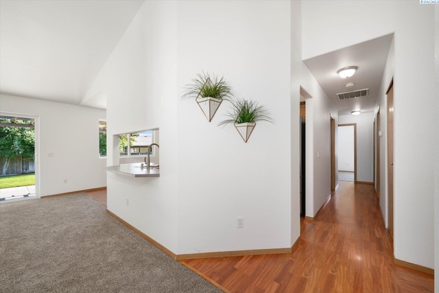 4607 Yuma Dr, Pasco, WA 99301 - corridor with a sink, light wood-type flooring, baseboards, and a towering ceiling