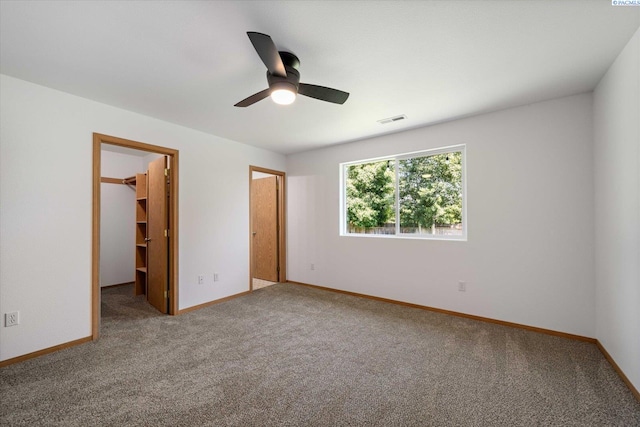4607 Yuma Dr, Pasco, WA 99301 - unfurnished bedroom featuring a spacious closet, carpet floors, baseboards, and ceiling fan