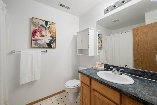 4607 Yuma Dr, Pasco, WA 99301 - full bathroom with vanity, toilet, baseboards, and tile patterned floors