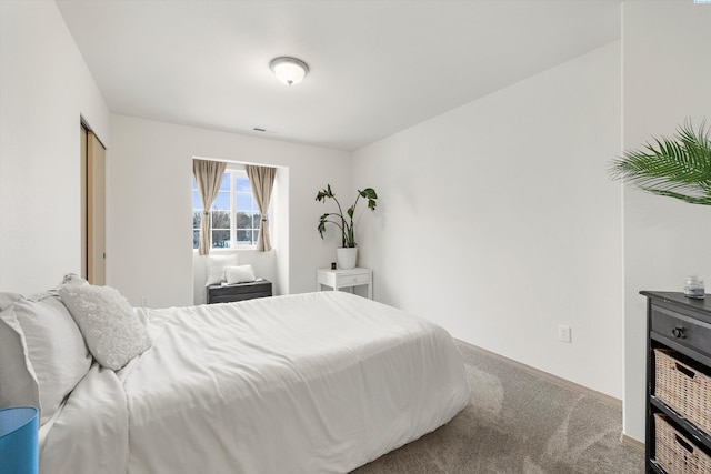 bedroom with carpet floors and baseboards