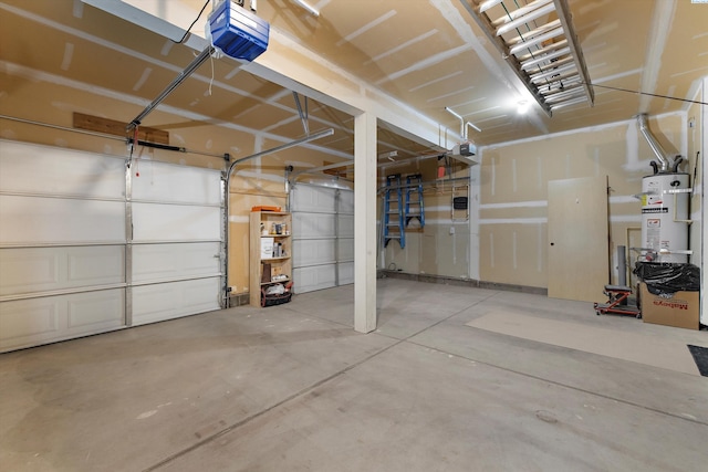 garage with strapped water heater and a garage door opener